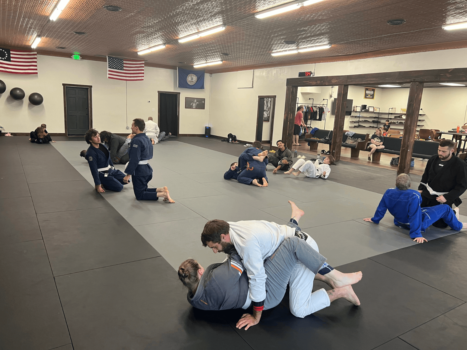 Adults training Gi BJJ on the mats