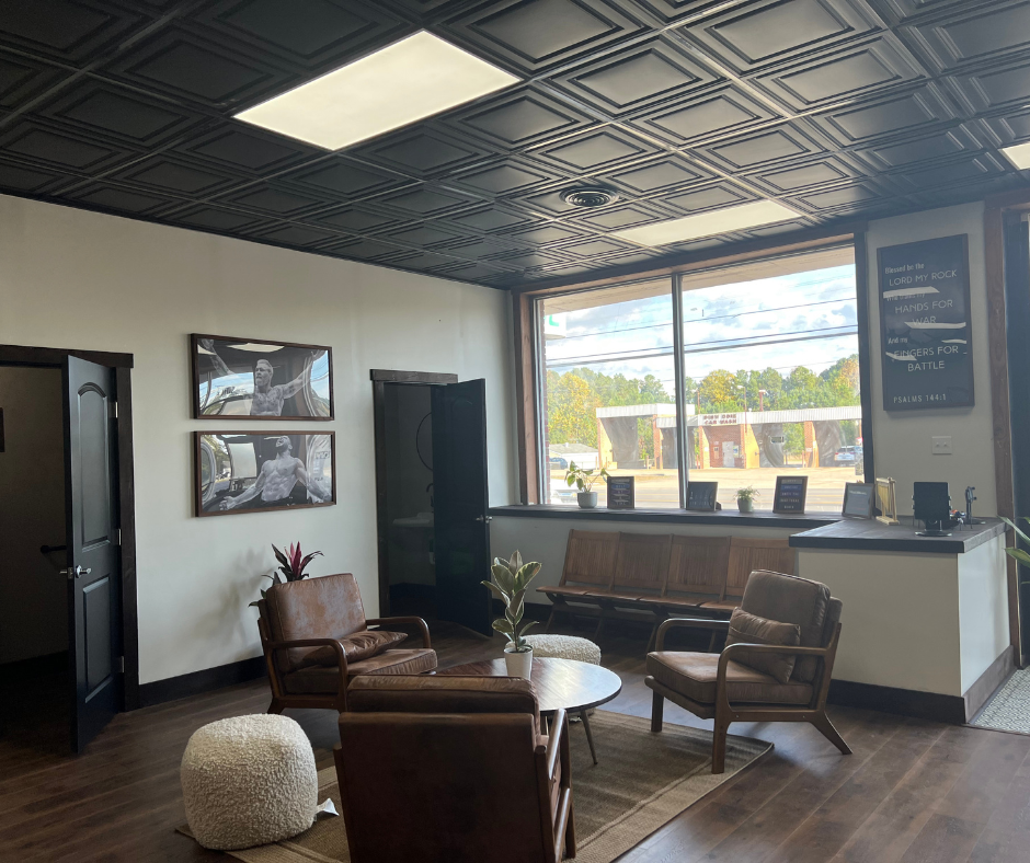 Lobby, front desk, and Psalm 144:1 wall at 144 BJJ